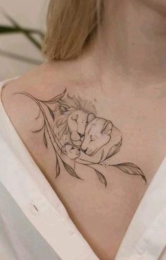 a woman's chest with a lion and flower tattoo on her left side shoulder