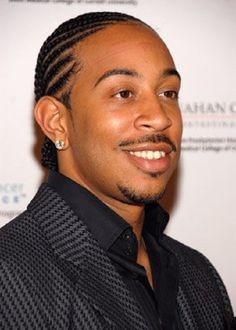 a man with braids and a black shirt