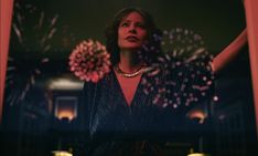 a woman standing in front of a mirror with fireworks coming out of her arms and hands