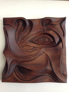 a wooden sculpture with an eye on it