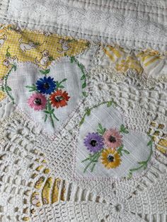 an embroidered quilt with flowers on it