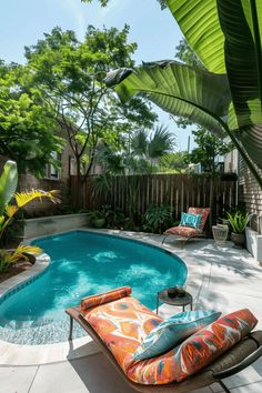 an outdoor swimming pool with chaise lounges and tropical trees in the back yard