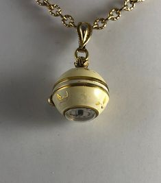 Nurse's Gift Vintage Hamilton Gold-Tone Metal Cream Enamel Ball WATCH Pendant Necklace pre owned but in good condition a few very small chips on this 1940's vintage Hamilton Ball watch pendant necklace. It is made from gold-tone metal decorated with soft cream color enamel bearing gold Leaves in a raised gold design. The watch has a wind-up mechanism and is keeping good timeplease click on photos for enlarged detail. The watch measures 3/4'' by 3/4'' and hangs from a 26 ich gold-tone metal chain Watch Pendant, Pendant Watch, Pendant Watches, Gold Leaves, Metal Ball, Ball Pendant, Gold Hands, Gold Enamel, Beautiful Watches