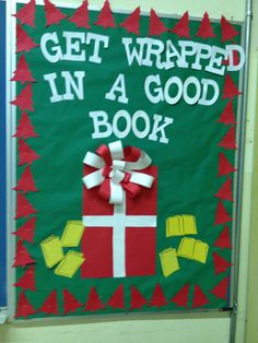 a sign that says get wrapped in a good book with a present tied to it