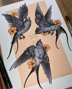 three birds with orange flowers in their beaks on a piece of paper next to markers