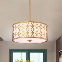 a chandelier hanging from the ceiling in a dining room with green doors and windows