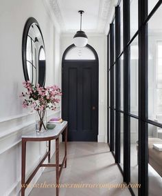 the hallway is clean and ready for guests to use it as an entrance way in this home