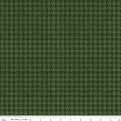 a green and black checkered fabric with a ruler in front of the bottom half