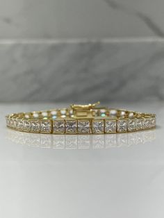 Back in stock! 18K Yellow Gold Over Sterling Silver 925 Tennis Bracelet with the finest 4mm 5A CZ Diamonds. The bracelet is absolutely gorgeous, it is fresh just came out from our studio!  Once you put it on, you're not gonna want take it off!! It is incredibly comfortable  Will Come in a box (one per package). Let me know if you have specific request please! Base:   Solid Sterling Silver 925 Finish: 18K Yellow Gold  Stone: 5A CZ Diamonds  ------------------------------------------- * We accept returns and exchanges at buyer's shipping expense within 14 days of delivery.  Just contact me within: 3 days of delivery Ship items back to me within: 14 days of delivery *Please note that shipping fee is not refundable. -------------------------------------------- We offer 30 day warranty on any p Classic Rectangular Tennis Bracelet For Anniversary, Classic Rectangular Cubic Zirconia Diamond Bracelet, Luxury Rectangular Diamond Cut Tennis Bracelet, Classic Rectangular Diamond Cut Tennis Bracelet, Classic Rectangular Tennis Bracelet For Weddings, Luxury Princess Cut Diamond Bracelet For Formal Occasions, Classic Cubic Zirconia Tennis Bracelet, Classic Rectangular Cubic Zirconia Tennis Bracelet, Rectangular Diamond Cut Tennis Bracelet For Anniversary