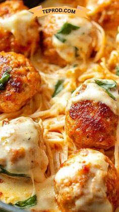 meatballs covered in cheese and spinach are being served on a plate with pasta