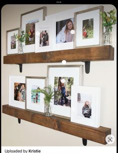 two wooden shelves with pictures and plants on them