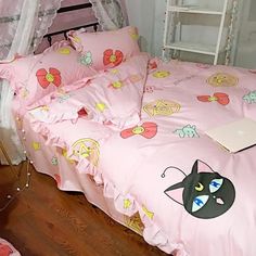 a bed with pink comforter and pillows on it in a room next to a ladder