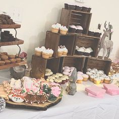 a table topped with lots of cakes and cupcakes