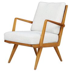 a wooden chair with white upholstered fabric on the back and armrests