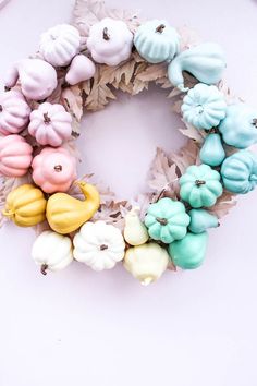 a wreath made out of fake doughnuts and leaves