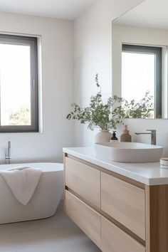 a bathroom with a tub, sink and window