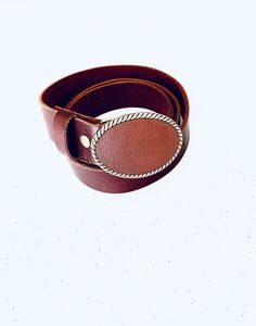 A classic brown leather belt buckle that will make any outfit stylish. The genuine leather buckle is designed on an antique brass finished oval buckle. Pair it with an interchangeable snap belt to style your outfit. The buckle can snap easily on and off to change the look of any outfit. The belt is not included and may be purchased for an additional cost. The buckle fits belts up to 1 1/2 inches or 38 mm wide. The buckles are packaged in an organza bag which is great for gift giving or storing. Classic Brown Belt With Brass Buckle, Formal Brown Belt Buckles With Brass Hardware, Classic Brown Belt With Concho Details, Classic Vintage Brown Belt Buckle With Brass Detail, Formal Brown Concho Belt Buckles, Classic Vintage Brown Belt Buckle With Belt Included, Classic Vintage Brown Belt Buckles With Antique Buckle, Brown Adjustable Belts And Suspenders With Antique Buckle, Classic Adjustable Brown Belt Buckles