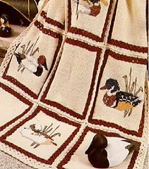 a crocheted blanket with ducks on it and the words mary max in red lettering