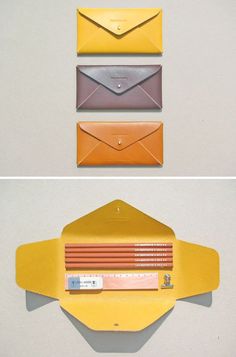 three different envelopes with pencils in them