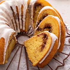 a bundt cake with white icing on a wire rack