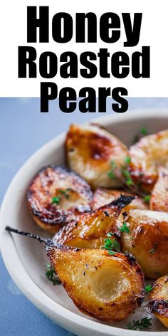 a white plate topped with roasted potatoes on top of a blue tablecloth and text that reads honey roasted pears