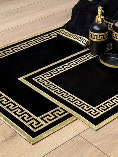 two black and gold rugs on the floor next to each other with bottles in them