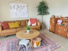 a living room filled with furniture and a potted plant on top of a table