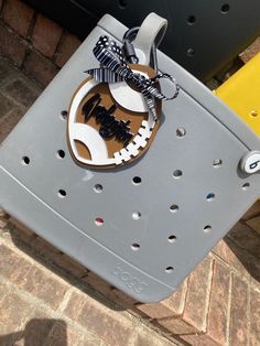 a close up of a metal object on a brick floor near a yellow and black chair