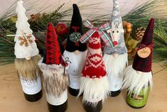 several wine bottles decorated with gnomes and snowmen