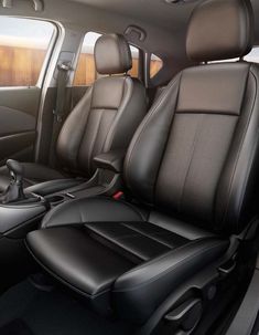 the interior of a car with black leather seats