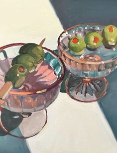 an oil painting of some fruit in a glass bowl on a blue tablecloth with another one sitting next to it