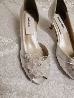 Wedding Peep toes satin shoes! Hand embellished with a vintage applique, a beautiful corded organza flower, and a small satin flower; elements used: pearls and tiny crystals; the back of the shoe is adorned with a cute satin flower. Please look at the pictures for details! Please note: white shoes have a slightly different lace under the flower than on the ivory ones. To buy color swatches: www.etsy.com/swatches/129787069/buy-color-swatch-samples-or-buy-lace FINAL SALE! THESE SHOES DESIGNS ARE N Vintage White Heels For Wedding, Open Toe Kitten Heels For Wedding, Fitted Open Toe Wedding Shoes For Ceremony, White Open Toe Kitten Heels For Wedding, Kitten Heel Wedding Shoes, Vintage Applique, Flower Elements, White Wedding Shoes, Kitten Heel Shoes