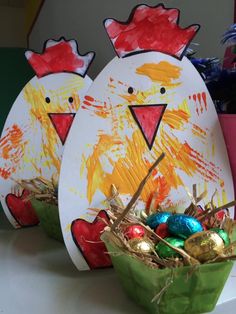 two paper plates with painted chickens and eggs in them