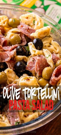 pasta salad with olives and ham in a glass bowl