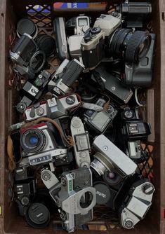 a box filled with lots of different types of cameras