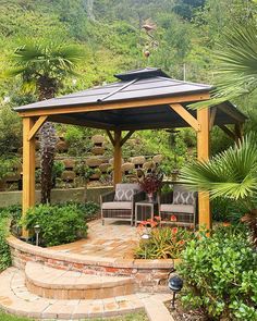 an outdoor gazebo surrounded by greenery and trees