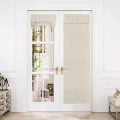 an open white door with curtains on it