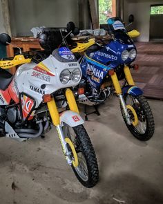 two motorcycles parked next to each other in a garage