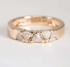 a gold ring with three pear shaped diamonds