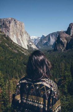 a woman standing in front of mountains and trees with the words, those who scare you