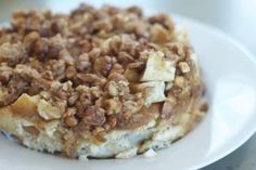 a close up of a plate of food with nuts on it and another dish in the background