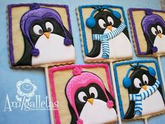 four decorated cookies in the shape of penguins