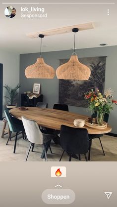 the dining room table is made out of wood and has two pendant lights above it