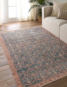 a living room with a couch and rug on the floor