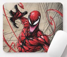 a spider - man mouse pad sitting on top of a desk