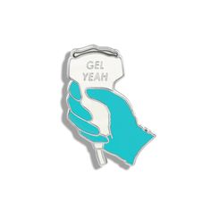 a blue and white enamel pin with the words gel yeah on it's side