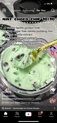 a bowl filled with green ice cream on top of a table next to a cell phone