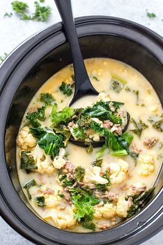 a bowl filled with broccoli, cauliflower and meat