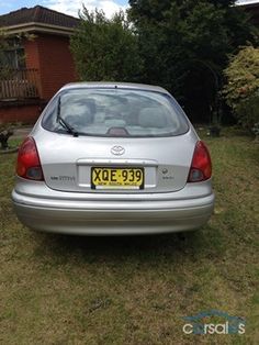 a silver car parked in front of a house