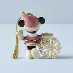 a mickey mouse figurine holding a snowflake